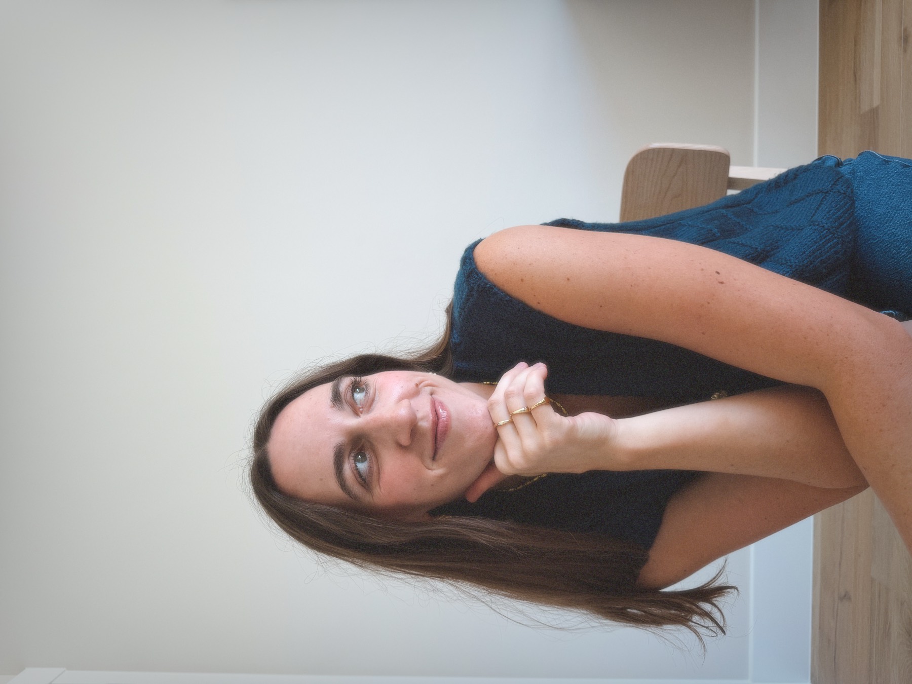 Kellie Yeck, resting her chin on her hand and looking away from the camera